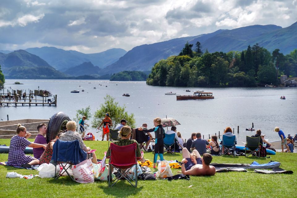 Crowds sunbathing in Crown Park on the banks of Derwentwater in the Lake District