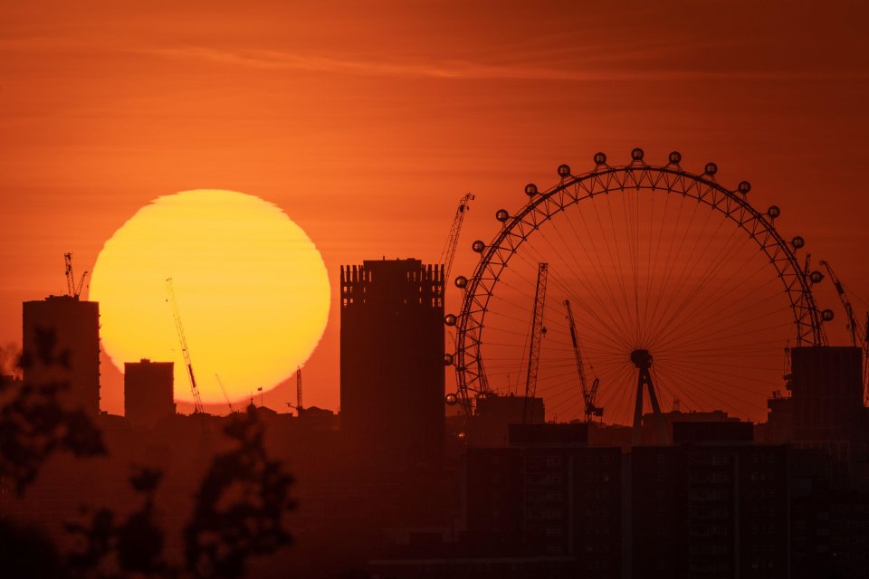 A dramatic evening sun sets near The London Eye