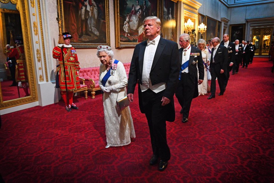 The Queen walks beside then US President Donald Trump through the East Gallery for the State Banquet at Buckingham Palace, London, on the first day of his three-day state visit to the UK on June 3 2019