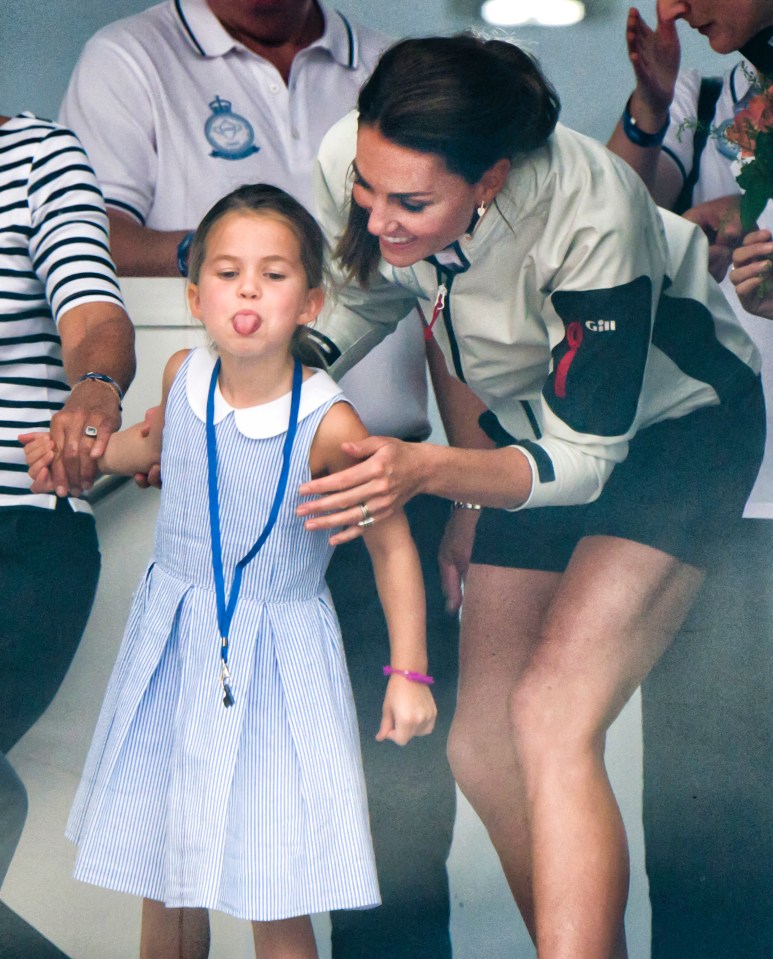 A cheeky Princess Charlotte sticks her tongue out while attending a presentation following the King's Cup Regatta on August 8, 2019 in Cowes with her mum, the Duchess of Cambridge