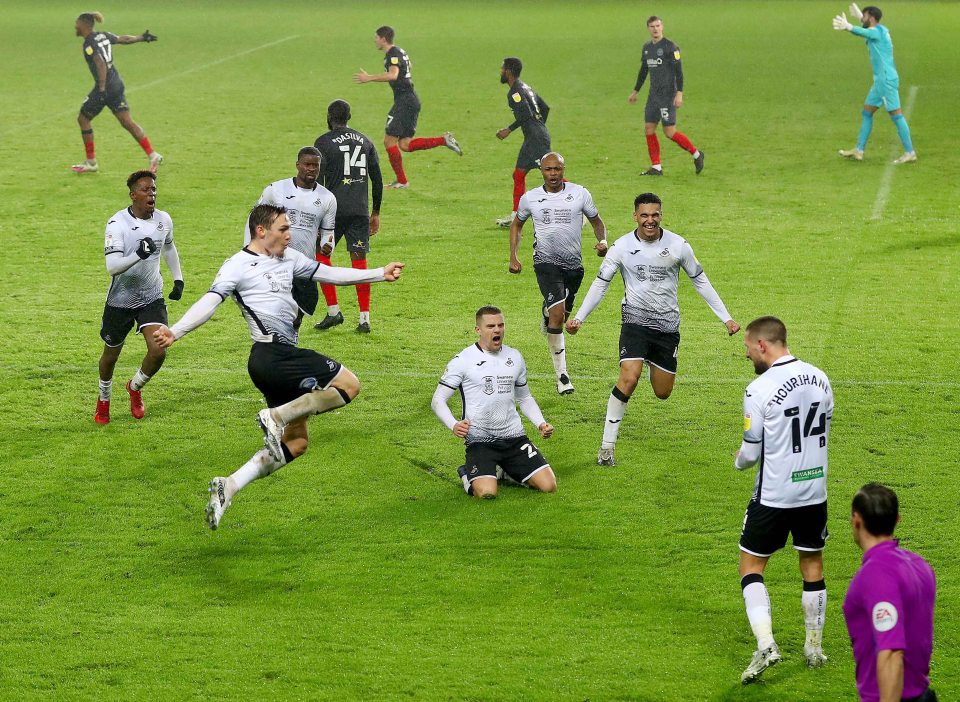 Conor Hourihane of Swansea City celebrates with team mates moments after scoring a goal to make the score 1-1