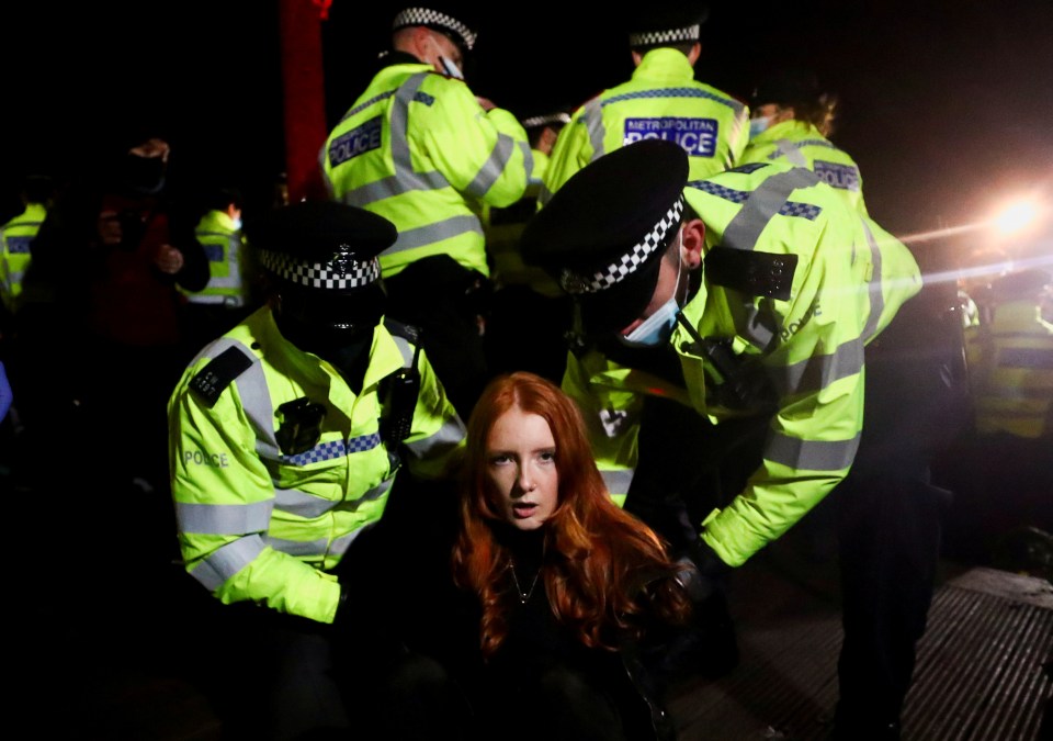 Cops detain Patsy Stevenson in London as people protest at a memorial site in Clapham Common Bandstand on March 13 2021, following the kidnap and murder of Sarah Everard