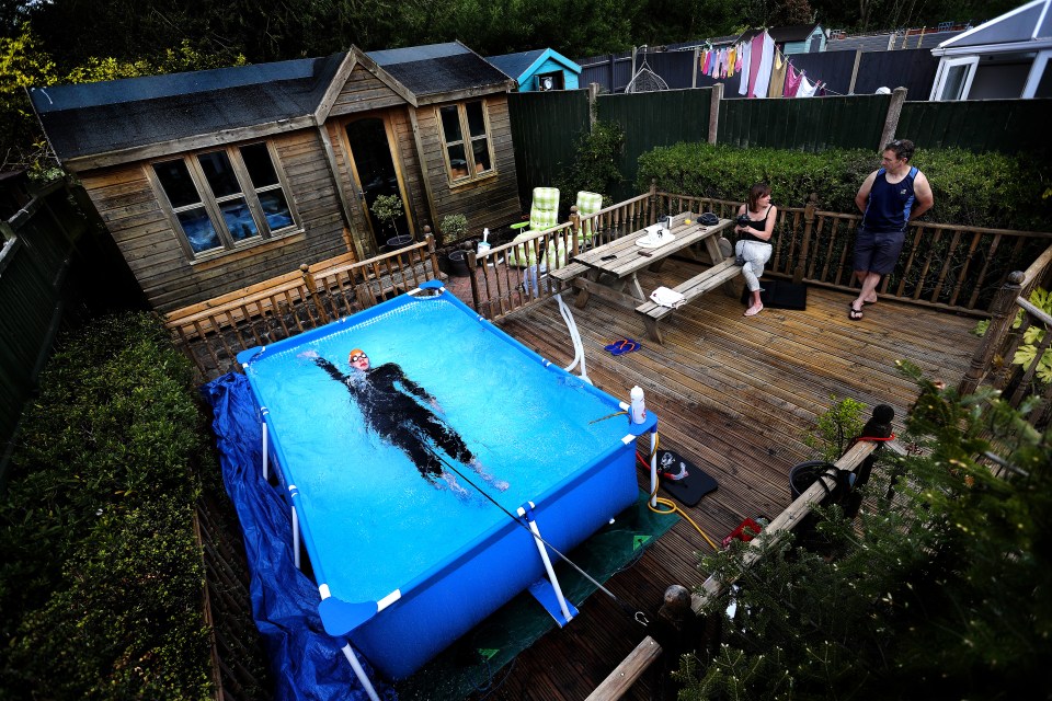 Triathlete Lloyd Bebbington trains in a pool in his garden, following the Coronavirus outbreak, in Newcastle-under-Lyme, April 26, 2020