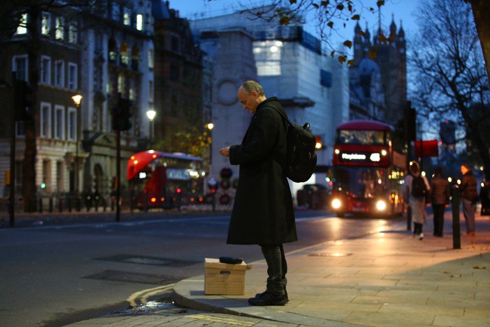 Dominic Cummings, ex special adviser to Boris Johnson, waits with a box of possessions on Whitehall after quitting No 10 on November 13 2020