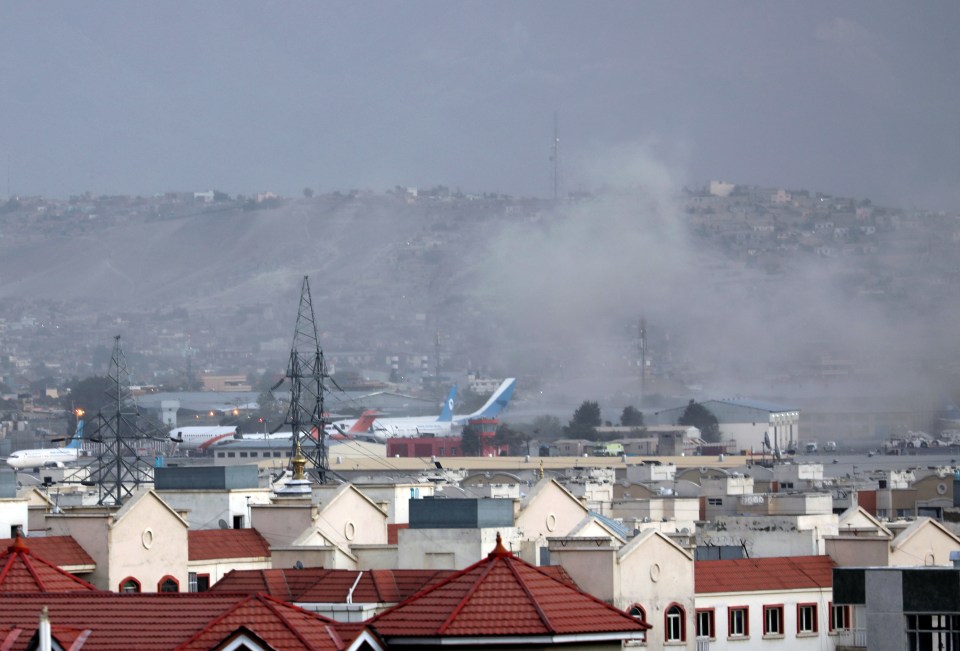 Smoke rises over the airport after the explosions