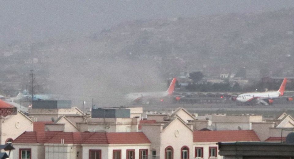 Smoke billows from the Kabul airport area after a blast