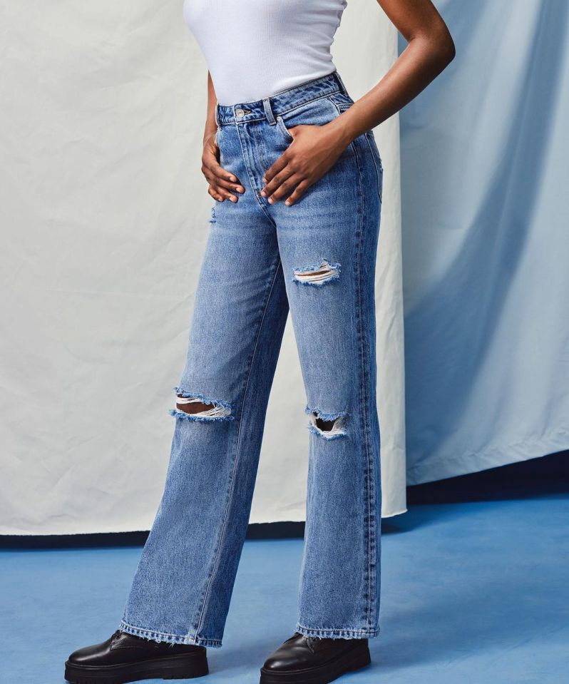 The second pair of distressed jeans have two rips over the knee