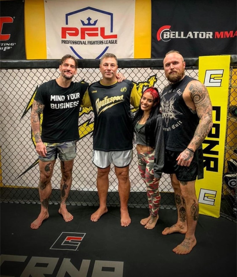 CM Punk with MMA coach Duke Roufus, Zelina Vega and Malakai Black