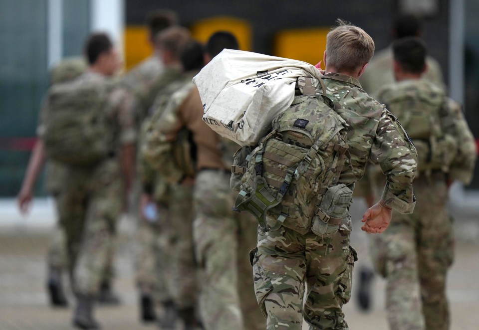 Soldiers were seen carrying their belongings along the tarmac