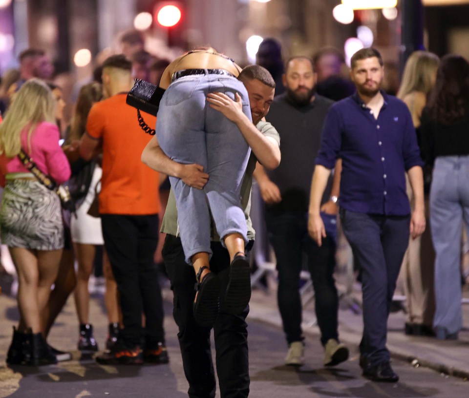 One reveller gave another a helping hand while walking through the busy streets