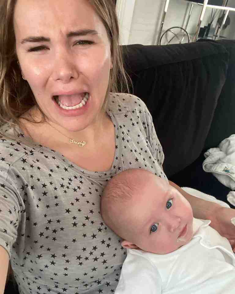 Georgia winces after her baby takes a poo on her