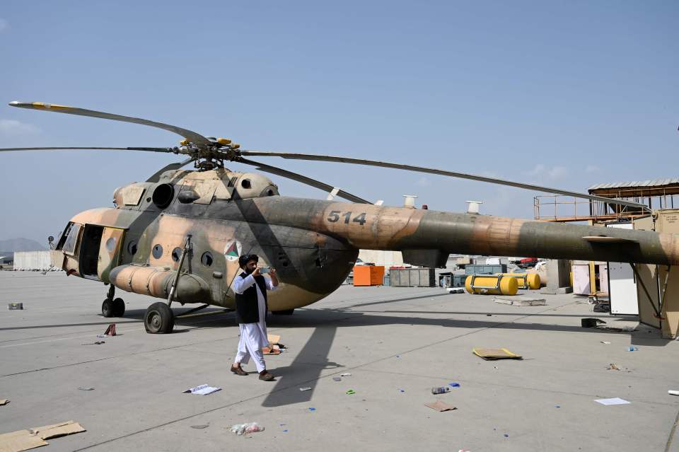 A Taliban member takes pictures of the helicopters