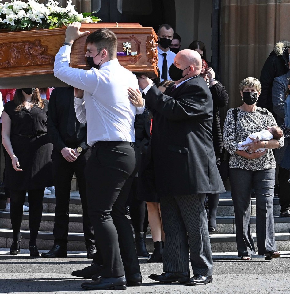 A loving relative carried Samantha's Willis's newborn daughter at the funeral