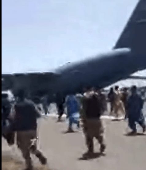 Desperate Afghans running behind the plane to get on board