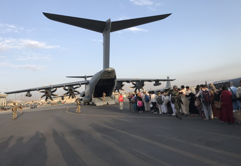 People queueing to board an evacuation flight at Kabul Airport yesterday