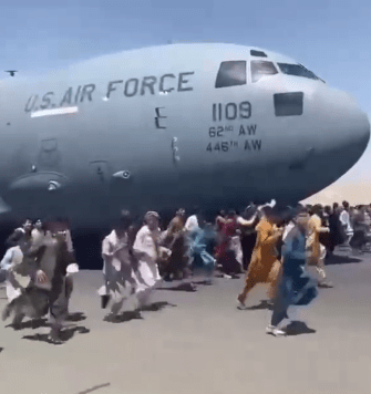 Afghans running alongside the C-17 plane as it was preparing to take off