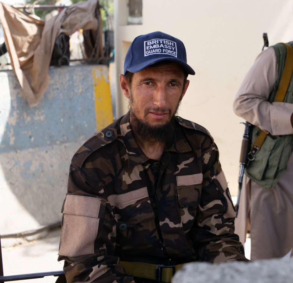 A Taliban guard at the embassy wearing a British cap