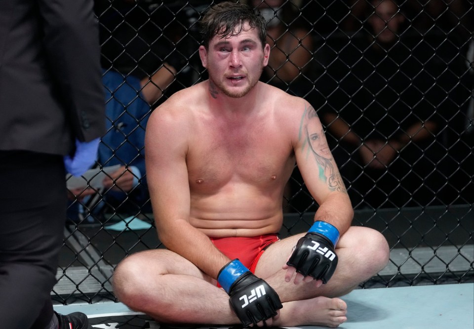 A dejected Darren Till looks on after tapping to Brunson's rear-naked choke