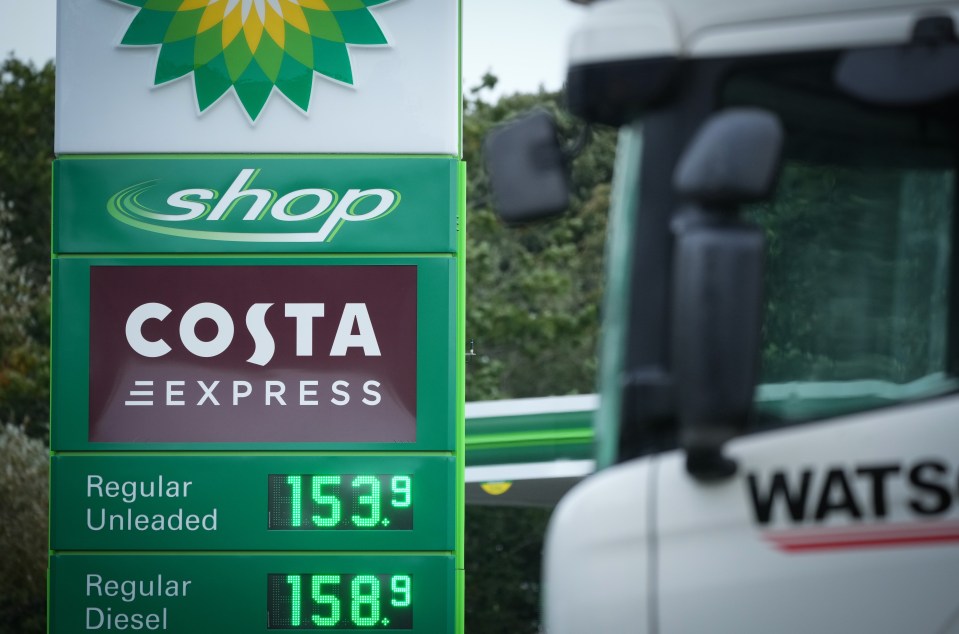 A sign displays the cost of petrol and diesel at a BP garage at the Knutsford motorway services