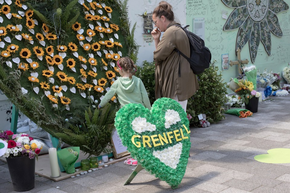 Floral tributes laid outside the Grenfell Wall