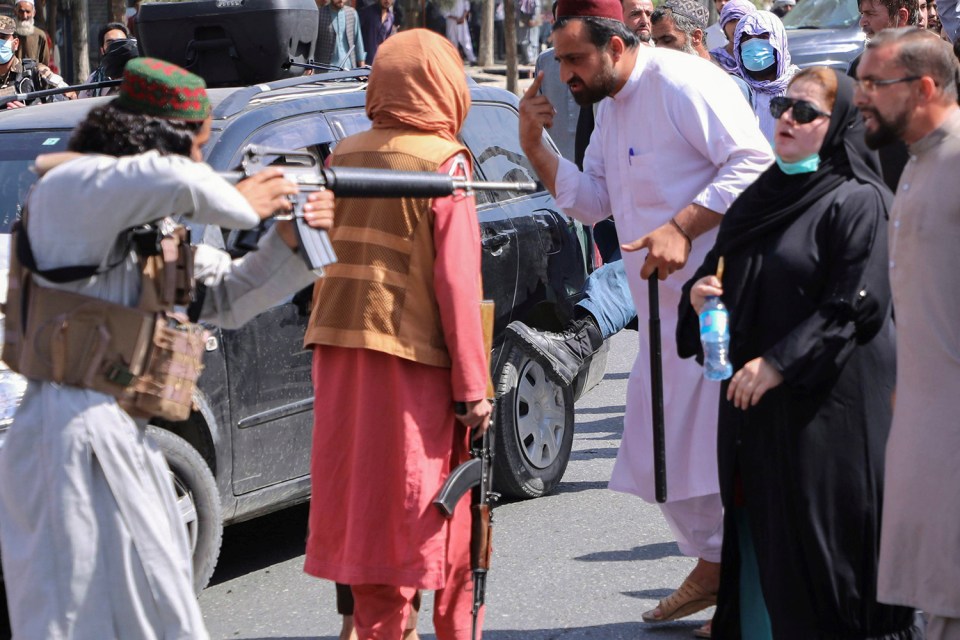 The woman bravely stares down a gunman who was aiming at her chest