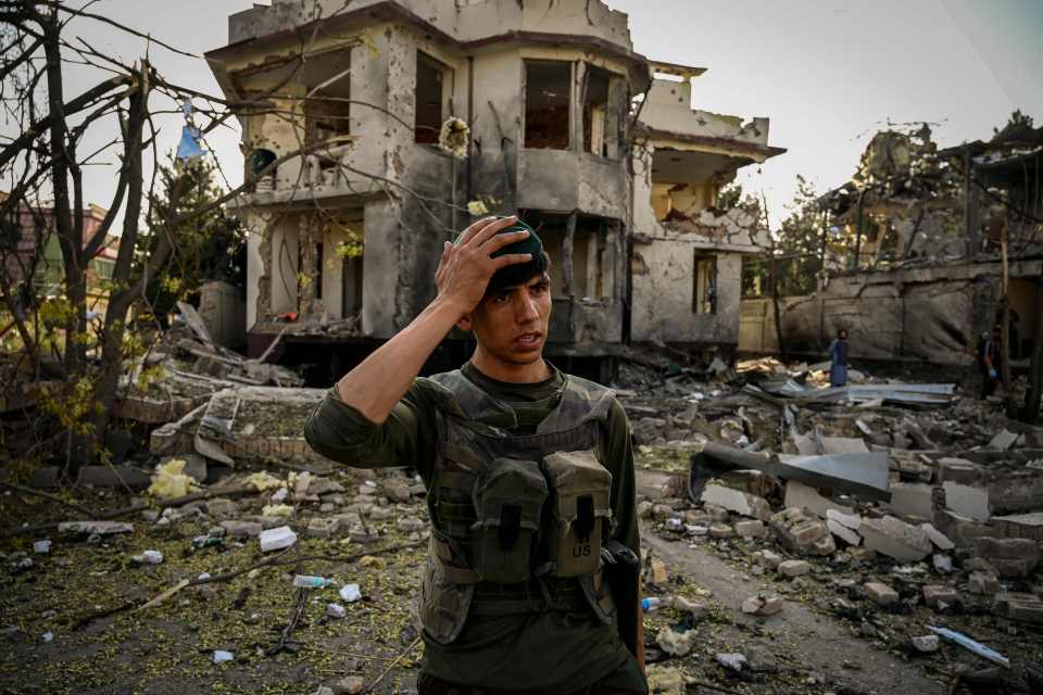 A Taliban soldier stands near an ISIS-K bomb attack last month near Kabul