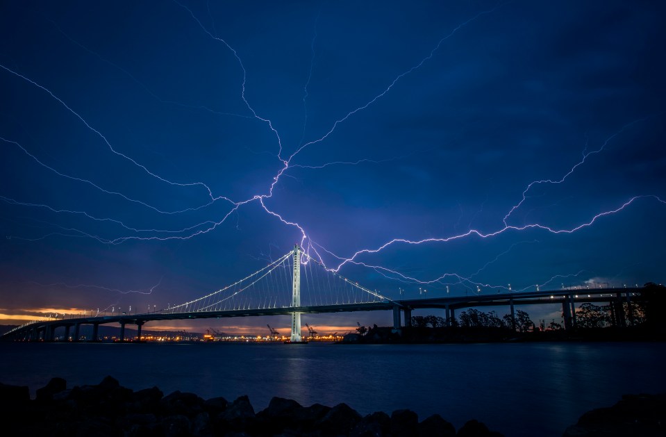 Lightning illuminates the sky over the eastern span of the Bay Bridge in San Francisco