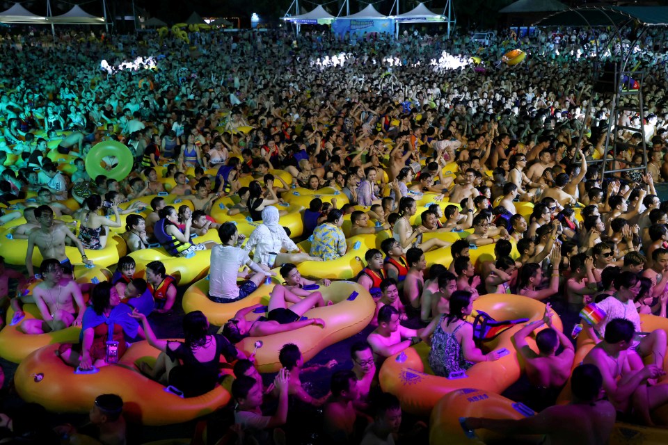 Crowds pack into a pool party in Wuhan, which is booming again almost two years after the Covid outbreak