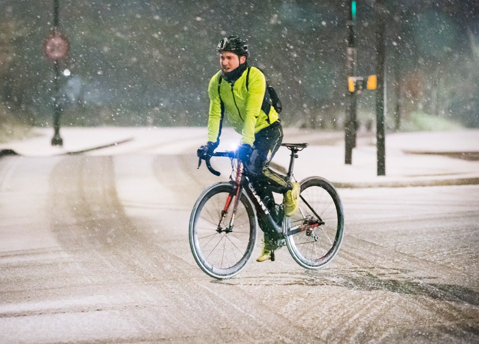 A London cyclist braves the snowy conditions in January