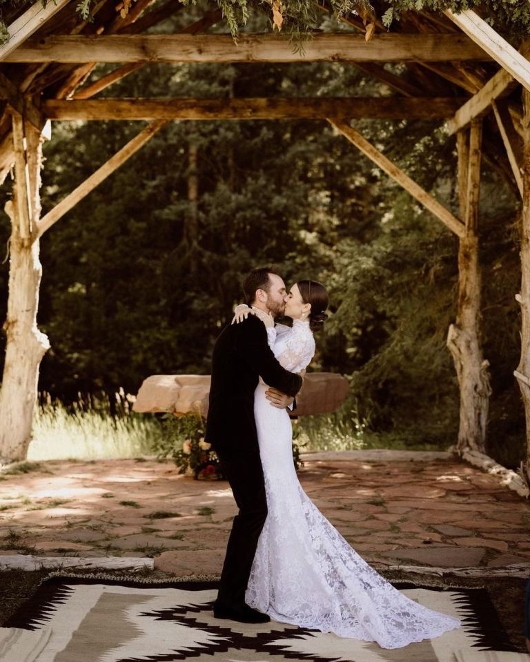 The star wore a floor-length white lace gown and veil, while McDowell chose a classic suit