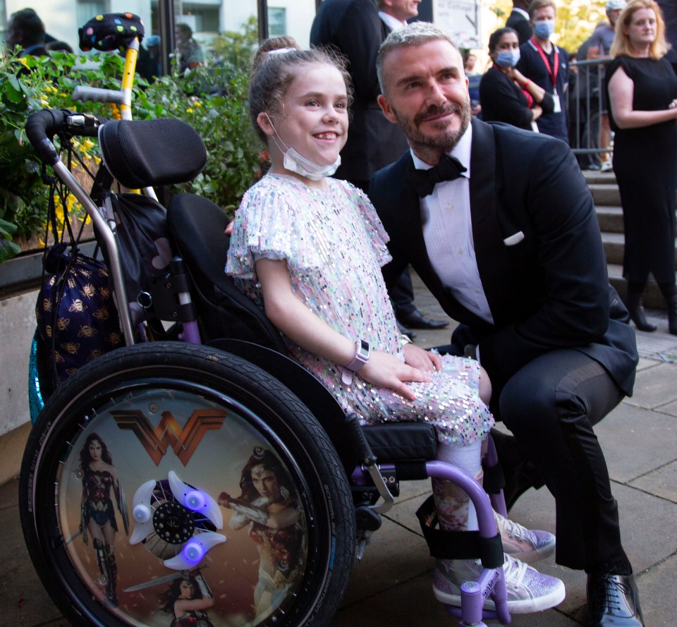 Becks met seven-year-old supergirl Carmela Chillery-Watson who has walked hundreds of miles dressed as Wonder Woman and raised £50,000 for charity