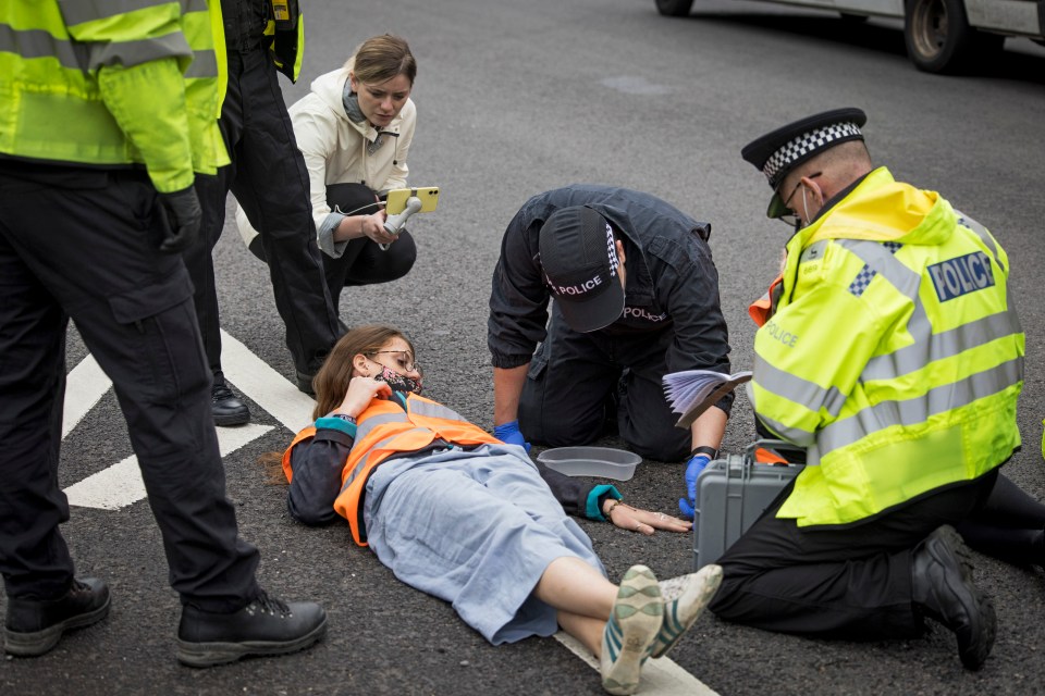 A protester glued her own hand to the road as part of the climate change action