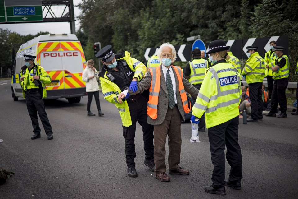 An elderly protester is arrested by police at junction 23 for the A1