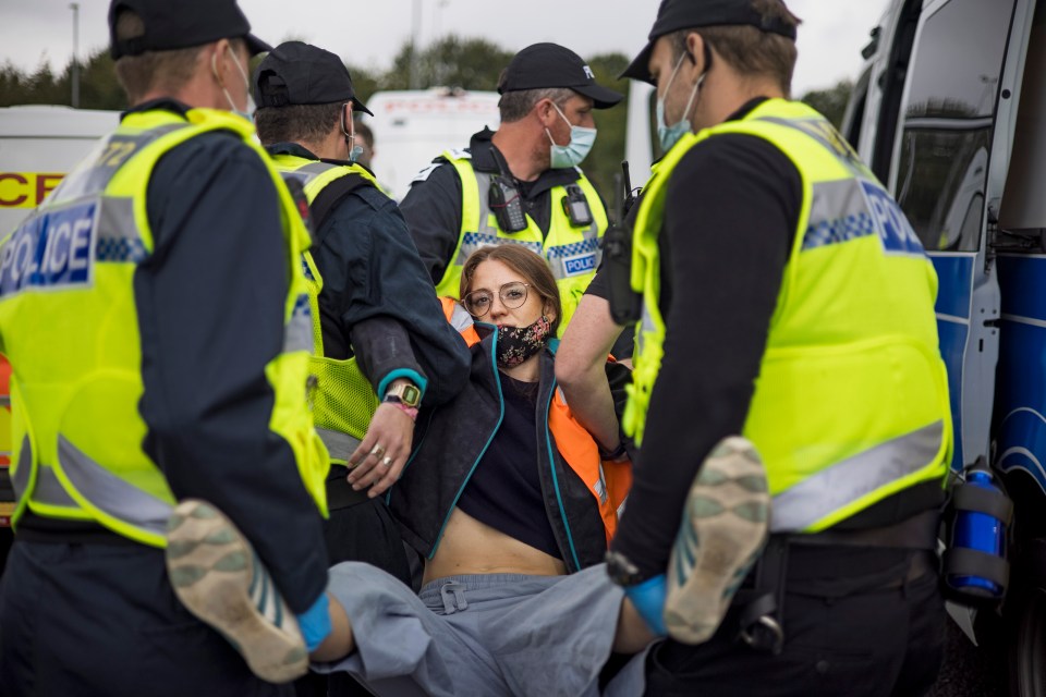 The police carry away an eco fanatic after a demonstration