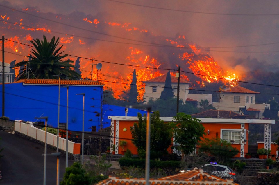 Lava flows behind houses following the huge eruption