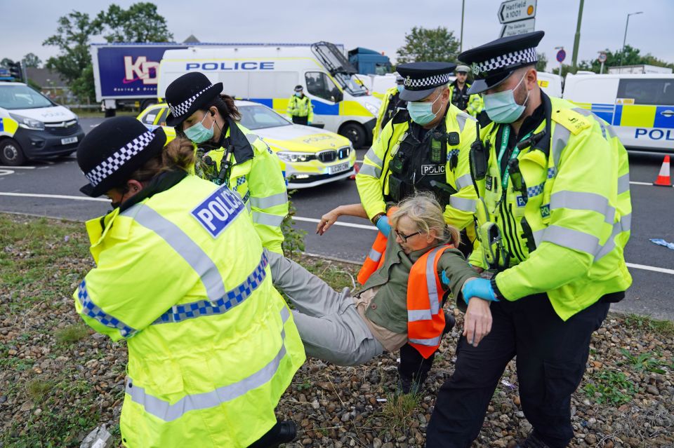 Tom estimates the three hours of lost work cost him £500 - pictured police carrying a woman at the A1M junction