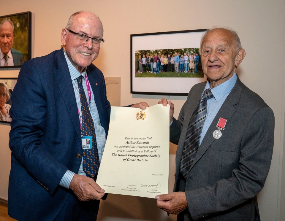 Delighted Arthur with his scroll and Zigi in front of the family portrait for the exhibition