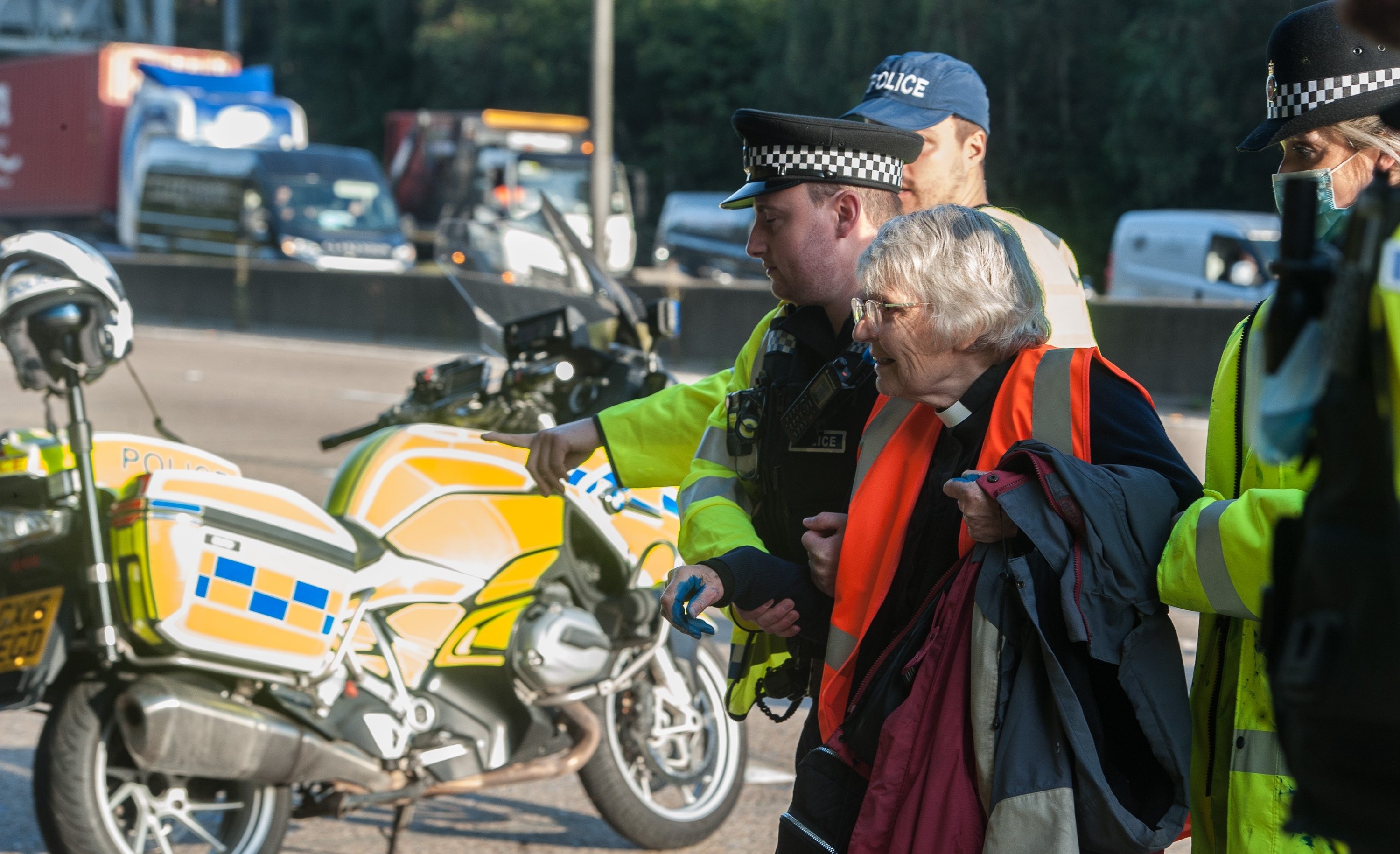 Police arrest a vicar as protestors from Insulate Britain block the M25