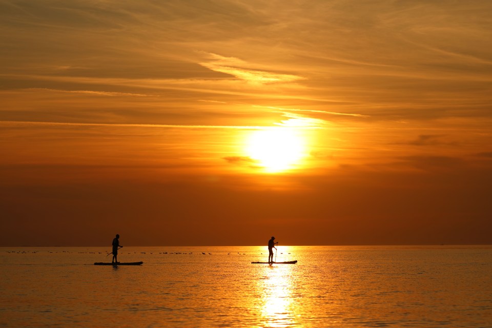 A paddle boarder welcomed the autumn equinox on the calm waters at Heacham, Norfolk