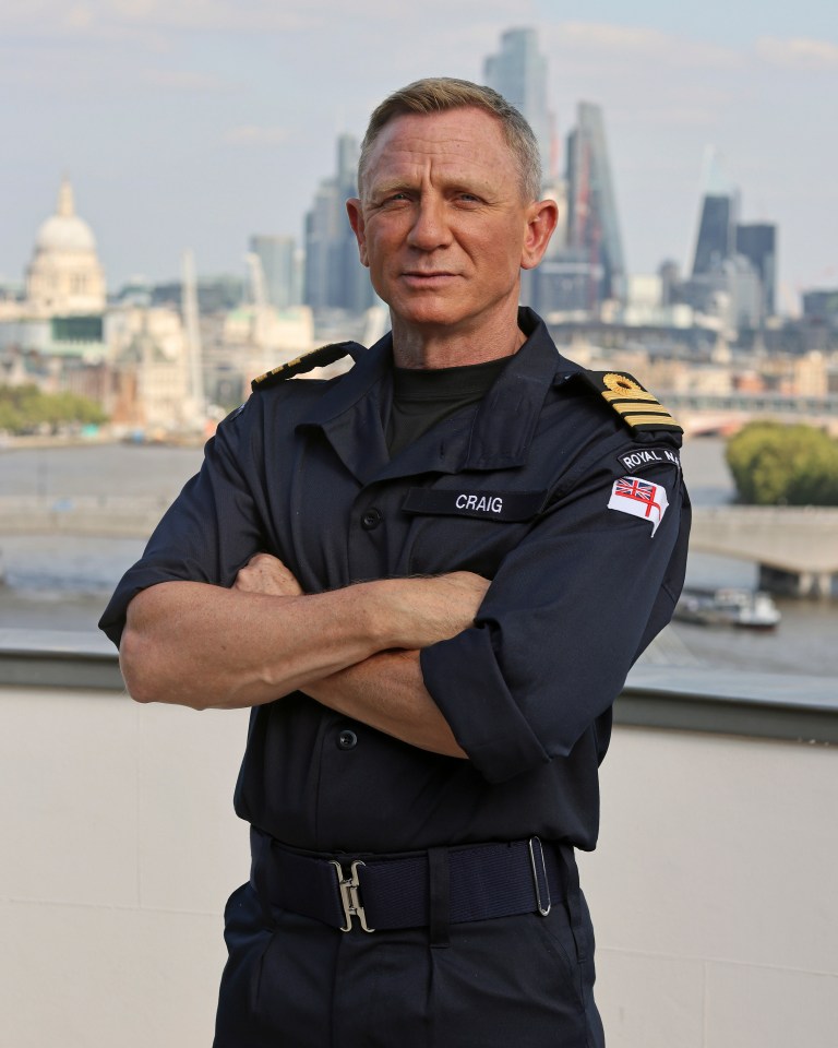 Daniel Craig proudly wears a Royal Navy uniform after he was made an honorary Commander