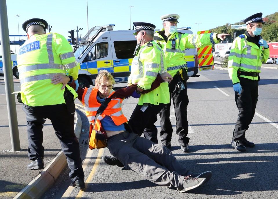 One eco-warrior being dragged away by police