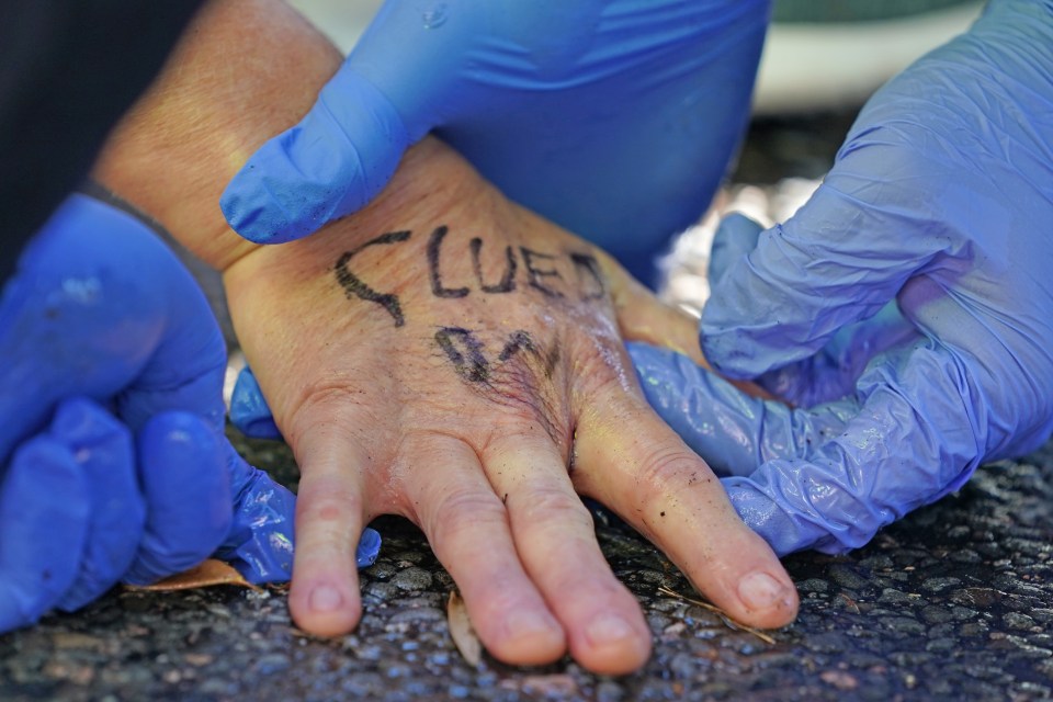 Officers work to free protesters who have glued themselves to the A20 in Kent