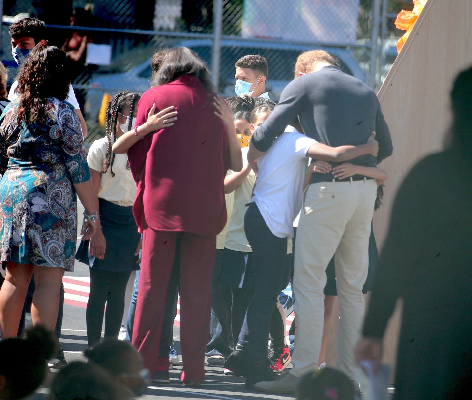 The Duke and Duchess embrace pupils at the school in Harlem