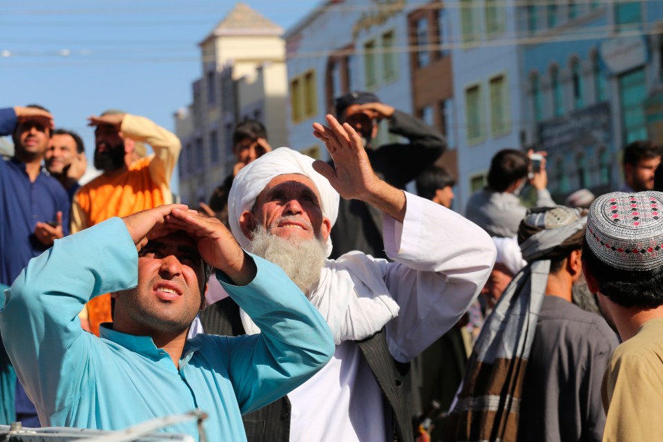 A mob men circled the city square as the body was lifted out of a truck and left handing from a crane