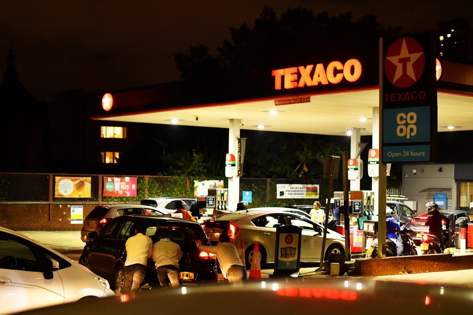 Helpers were seen shoving a car which had run out of fuel altogether onto the forecourt of a petrol station in south London last night