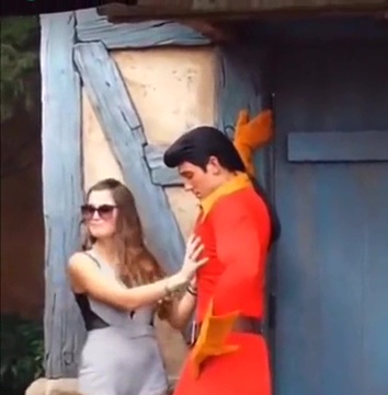 A woman puts her hand on Gaston's pecs