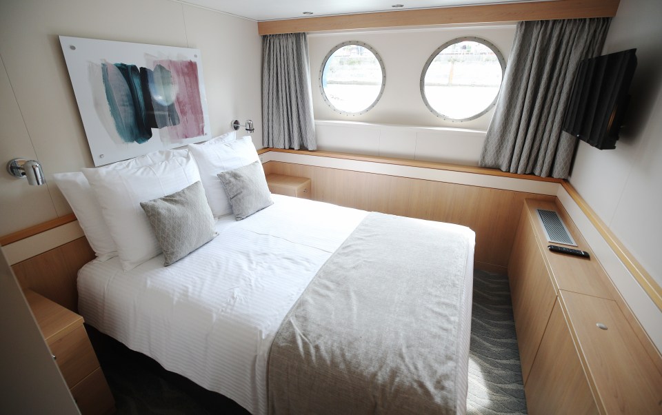 A standard cabin with a rainfall shower, double bed and bathroom with Molton Brown toiletries