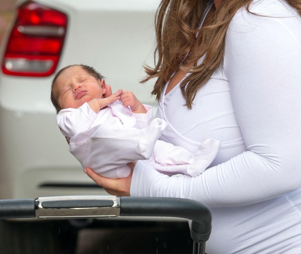 The adorable tot was shown with her eyes shut as she gently put her back