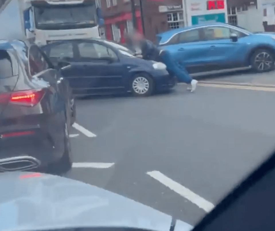 The motorist then DRIVES into the man - pushing him onto his bonnet