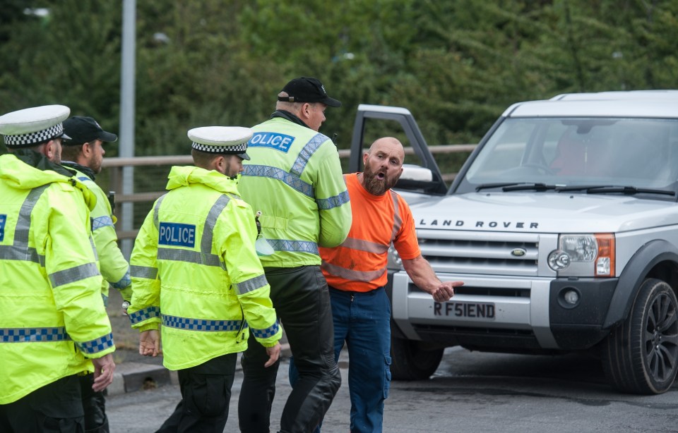 Officers had to hold back a maddened motorist after traffic was again brought to a standstill